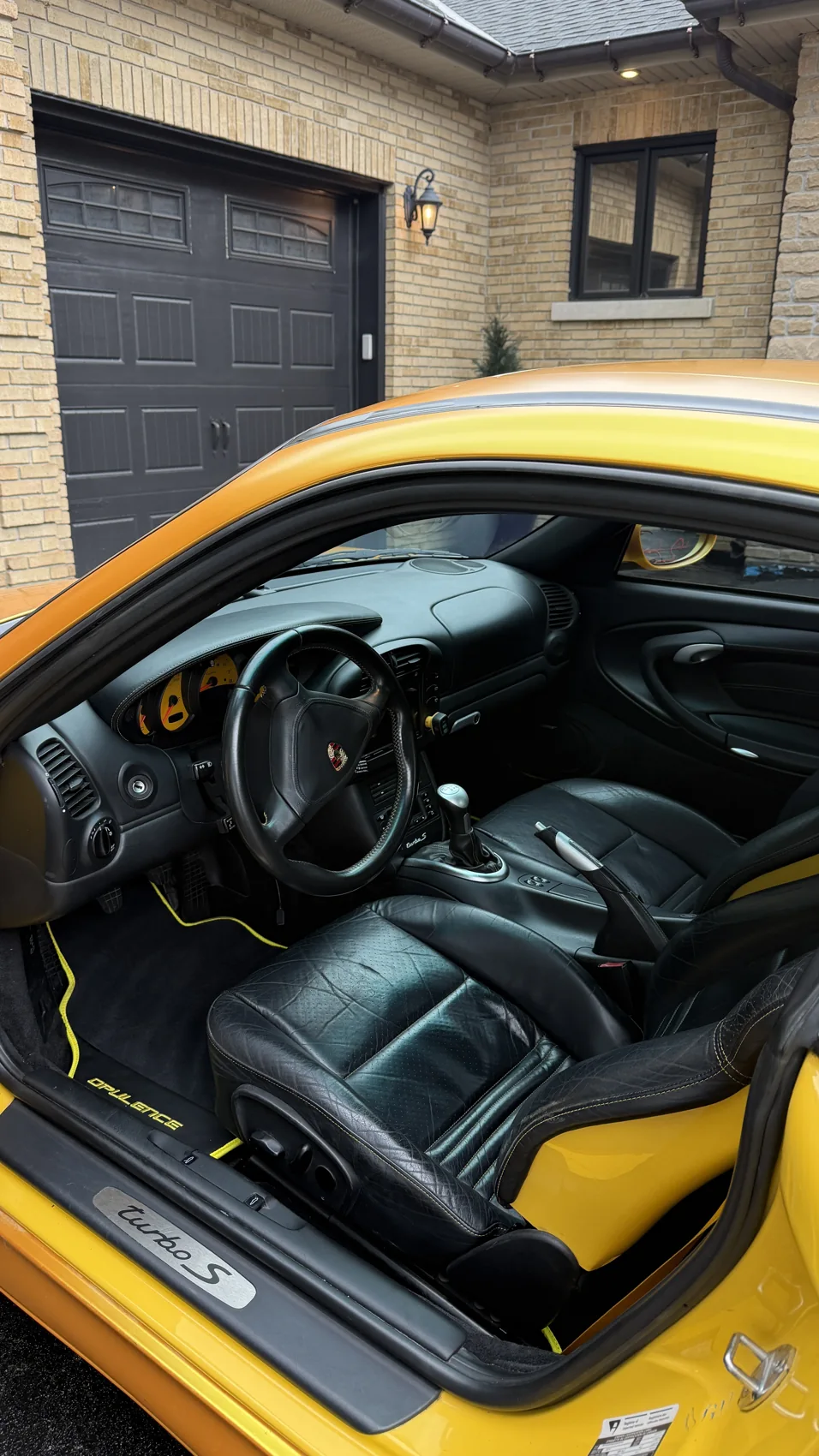 Black leather Porsche seats and cockpit after interior detailing