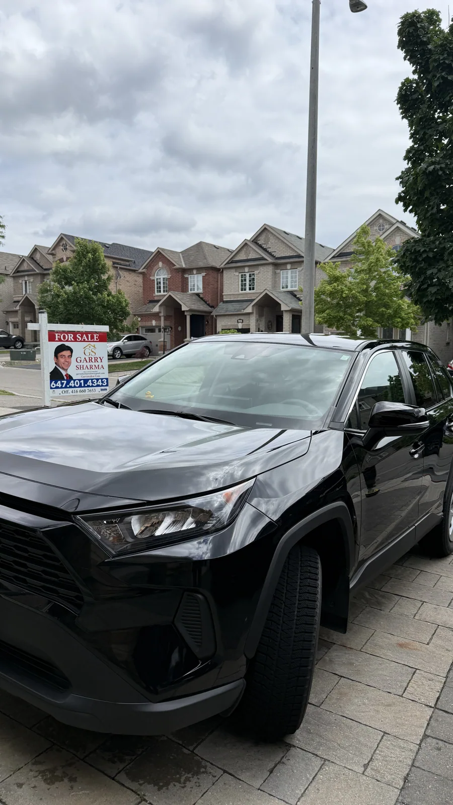 Black luxury vehicle photographed after an exterior detail