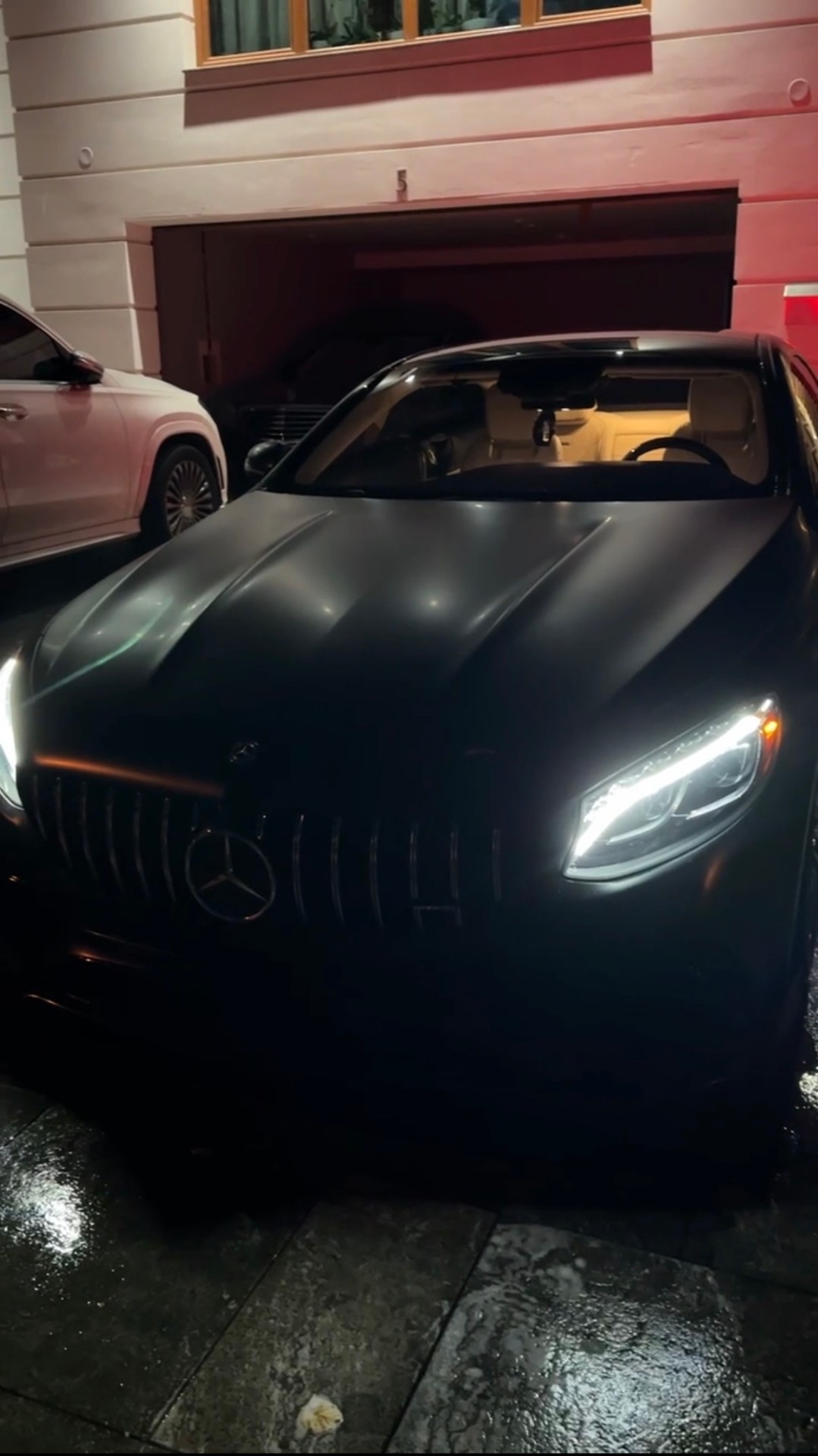 Matte black AMG GT at night after detail